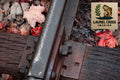 Close-up of a metal rail with gravel and leaves, featuring Laurel Creek Imaging logo.